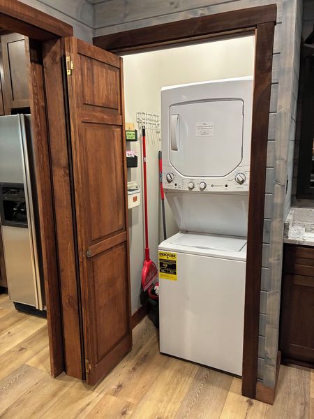 Stacked washer and dryer in a closet beside the kitchen
