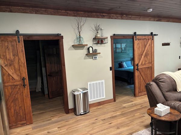 Sliding barn doors opening to the bedroom and bathroom off the living room