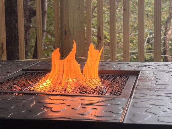 Flames in a square propane fire table on the overlook deck