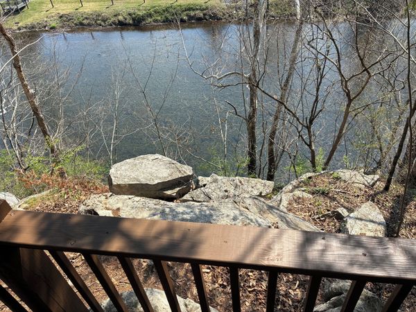 Little River seen from the overlook deck railing, with large boulders on the bank