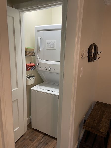 Stacked washer and dryer in a closet off the hallway